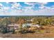 Stunning aerial view showing a bright home situated among trees and marshland under a bright sky with puffy clouds at 116 Peninsula Dr, Ravenel, SC 29470