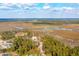 An aerial view of a residential area surrounded by water and trees on a sunny day at 116 Peninsula Dr, Ravenel, SC 29470