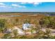 Aerial view of a marsh-front home and surrounding wooded land at 116 Peninsula Dr, Ravenel, SC 29470