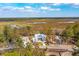 Panoramic aerial view of a home surrounded by trees and scenic landscape, with a bright, sunny sky above at 116 Peninsula Dr, Ravenel, SC 29470