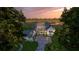 Aerial view of a charming two-story farmhouse with an attached two-car garage near a pond at 116 Peninsula Dr, Ravenel, SC 29470