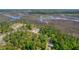 Scenic aerial view of coastal wetlands, wooded area and a charming home under construction at 116 Peninsula Dr, Ravenel, SC 29470
