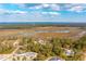 An aerial view of a residential area surrounded by water and trees on a clear day at 116 Peninsula Dr, Ravenel, SC 29470
