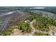 Beautiful aerial view of coastal wetlands and wooded area with a new home under construction at 116 Peninsula Dr, Ravenel, SC 29470
