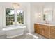 Bright bathroom with freestanding tub, chandelier, and marble shower at 116 Peninsula Dr, Ravenel, SC 29470