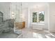 Bright bathroom with freestanding tub, chandelier, and marble shower at 116 Peninsula Dr, Ravenel, SC 29470