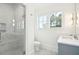 Bright bathroom featuring a glass shower, a window, and light blue cabinetry at 116 Peninsula Dr, Ravenel, SC 29470