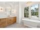 Bright bathroom with freestanding tub, chandelier, and marble shower at 116 Peninsula Dr, Ravenel, SC 29470