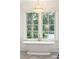Bright bathroom with freestanding tub and view of landscaped yard at 116 Peninsula Dr, Ravenel, SC 29470