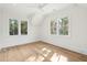 Bright, minimalist bedroom with hardwood floors and large windows offering scenic views at 116 Peninsula Dr, Ravenel, SC 29470