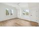 Bright bedroom featuring hardwood floors, white walls, large windows, and a ceiling fan at 116 Peninsula Dr, Ravenel, SC 29470