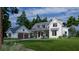 Charming two-story farmhouse-style home with a large front yard and attached two-car garage at 116 Peninsula Dr, Ravenel, SC 29470