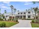 Beautiful white farmhouse-style home with a metal roof, attached garage, and manicured landscaping at 116 Peninsula Dr, Ravenel, SC 29470