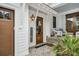 Inviting front porch featuring brick flooring, a wooden door, and cozy seating area at 116 Peninsula Dr, Ravenel, SC 29470