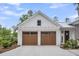 Two-car garage with wooden doors and decorative pergola at 116 Peninsula Dr, Ravenel, SC 29470