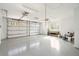 Spacious two-car garage with a clean epoxy floor, bright lighting, and ample room for storage at 116 Peninsula Dr, Ravenel, SC 29470