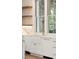Farmhouse kitchen featuring white cabinets, gold faucet, and open shelving at 116 Peninsula Dr, Ravenel, SC 29470