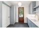 Functional laundry room with sleek gray cabinetry, marble countertops, and a utility sink at 116 Peninsula Dr, Ravenel, SC 29470