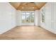 Bright living room with wood ceiling, large windows and trim details at 116 Peninsula Dr, Ravenel, SC 29470