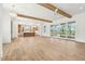 Large living room with wood beams, chandelier, and sliding glass doors leading to an outdoor area at 116 Peninsula Dr, Ravenel, SC 29470