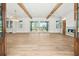 Open living room with exposed beams, wood floors, and sliding glass doors at 116 Peninsula Dr, Ravenel, SC 29470
