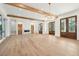 Open living area featuring exposed wood beams, a fireplace, built-ins, and wood-framed glass doors at 116 Peninsula Dr, Ravenel, SC 29470