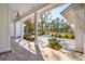 Covered porch overlooking the landscaped yard at 116 Peninsula Dr, Ravenel, SC 29470