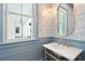 Stylish powder room with designer wallpaper, marble countertop, and brass fixtures at 116 Peninsula Dr, Ravenel, SC 29470