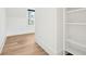 Bright room featuring hardwood floors, white walls, a window, and built-in shelving at 116 Peninsula Dr, Ravenel, SC 29470