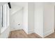 Bright room with hardwood floors, white walls, a window, and a small door at 116 Peninsula Dr, Ravenel, SC 29470