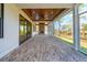 Relaxing screened porch featuring brick floors, wood ceiling, and views of the backyard at 116 Peninsula Dr, Ravenel, SC 29470