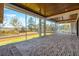 Inviting screened porch with brick floor, wood ceiling, and scenic outdoor views at 116 Peninsula Dr, Ravenel, SC 29470