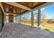 Elegant screened porch with brick floor, wood ceiling, and outdoor fireplace at 116 Peninsula Dr, Ravenel, SC 29470