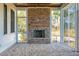 Cozy screened porch with brick floor, brick fireplace and scenic backyard view at 116 Peninsula Dr, Ravenel, SC 29470