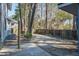 Large backyard offers plenty of space with mature trees, privacy fence, and concrete patio at 117 Lewisfield Dr, North Charleston, SC 29418