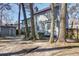Exterior view of backyard featuring mature trees, storage shed, and access to screened patio at 117 Lewisfield Dr, North Charleston, SC 29418