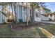 Charming two-story home with light-blue painted wood surrounded by trees at 117 Lewisfield Dr, North Charleston, SC 29418