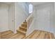 Bright foyer featuring wood-look flooring and a staircase to the upper level at 117 Lewisfield Dr, North Charleston, SC 29418