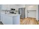 Bright kitchen features white cabinets, stainless steel appliances, light countertops and access to the laundry room at 117 Lewisfield Dr, North Charleston, SC 29418