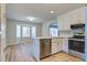 Bright kitchen features white cabinets, stainless steel appliances, light countertops adjacent to the dining room at 117 Lewisfield Dr, North Charleston, SC 29418