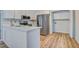 Bright kitchen features white cabinets, stainless steel appliances, light countertops and access to the laundry area at 117 Lewisfield Dr, North Charleston, SC 29418