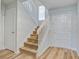 Well lit Stairwell featuring hardwood steps, white railing and trim at 117 Lewisfield Dr, North Charleston, SC 29418