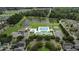 Aerial view showcasing a community pool, lake, clubhouse, and surrounding lush green landscape at 123 Hyacinth St, Summerville, SC 29483