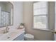 Compact bathroom with a window, light-colored walls, and a vanity sink at 123 Hyacinth St, Summerville, SC 29483