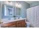 Bright bathroom featuring a double sink vanity, framed mirrors, and stylish shower curtain at 123 Hyacinth St, Summerville, SC 29483