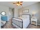 Comfortable bedroom featuring neutral walls, wood-look flooring, and a view into the en-suite bathroom at 123 Hyacinth St, Summerville, SC 29483