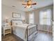 Cozy bedroom with neutral tones, wood-look floors, and ample natural light from two windows at 123 Hyacinth St, Summerville, SC 29483