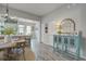 Charming dining area with stylish furniture, complemented by a decorative cabinet and an open-concept kitchen at 123 Hyacinth St, Summerville, SC 29483