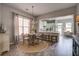 Elegant dining area with stylish chandelier, round table, and an open view into the adjacent kitchen at 123 Hyacinth St, Summerville, SC 29483