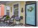 Inviting front porch featuring wicker rocking chairs, plants, and a decorative door with a welcoming wreath at 123 Hyacinth St, Summerville, SC 29483